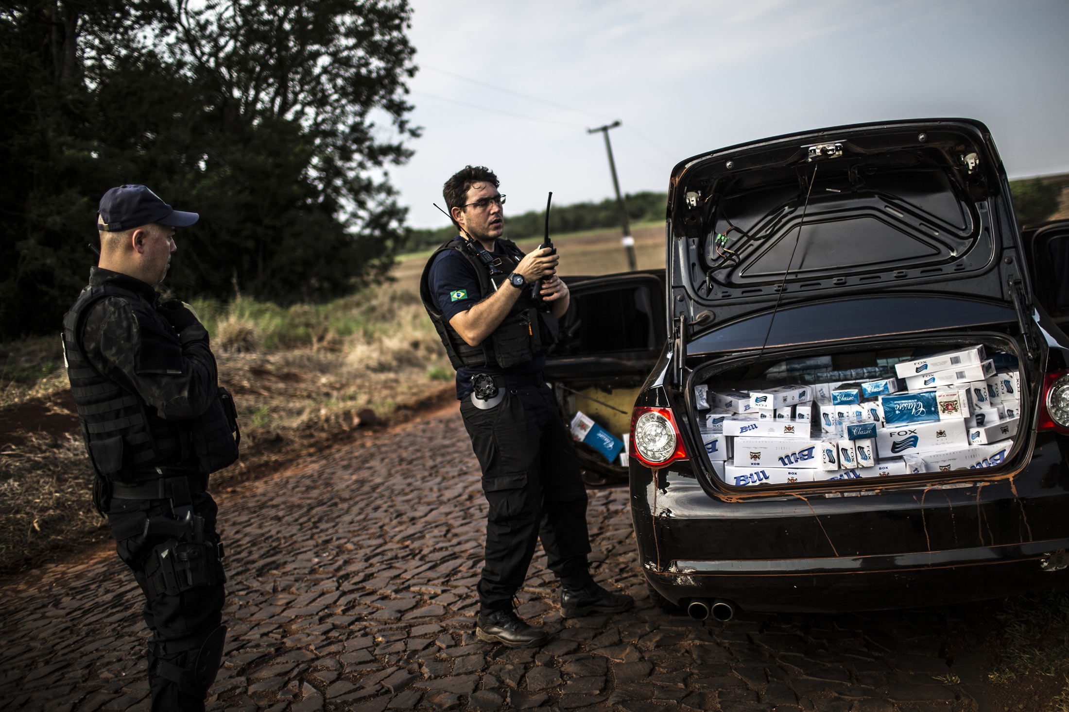 A Brazilian Tax Authority agent communicates to colleagues that he has discovered a load of smuggled cigarettes near the border with Paraguay in Foz do Iguacu, Brazil Oct. 7, 2015.