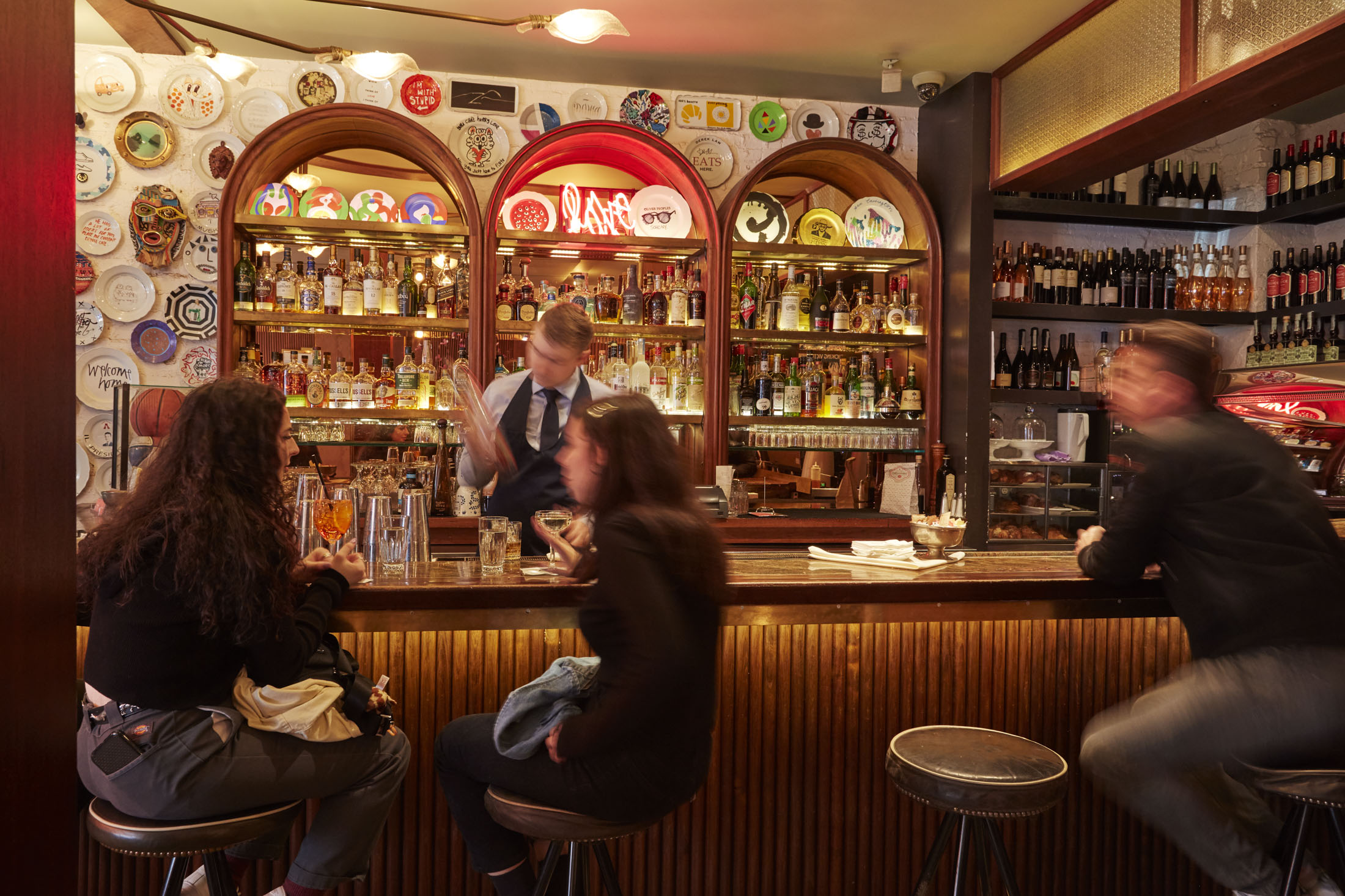 The elegant Milanese outpost, with prime sidewalk seating in SoHo (bottom), serves everything from cocktails to pastries and slider-sized sandwiches.