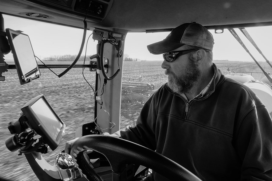 Bob Davis checks the monitor while planting corn on the Kevin Skunes Farm northeast of Arthur. The monitors tell him soil depth, seed spacing, moisture, seed count and fertilizer levels.