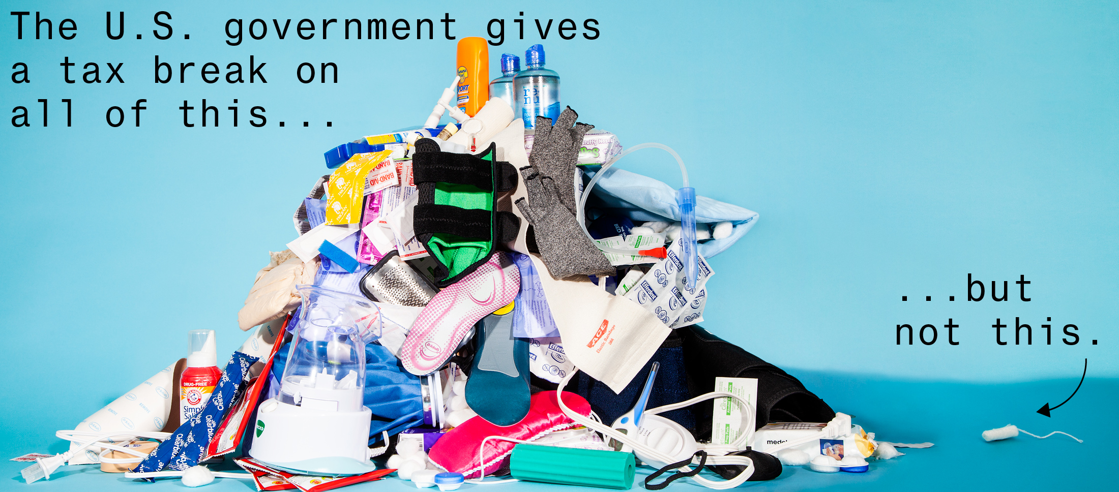 Photograph of pile of over-the-counter medical products next to one unwrapped tampon