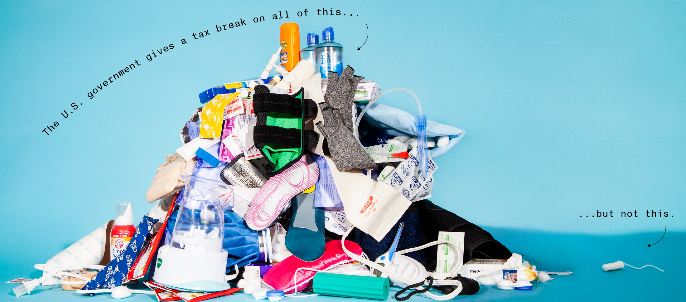 Photograph of pile of over-the-counter medical products next to one unwrapped tampon