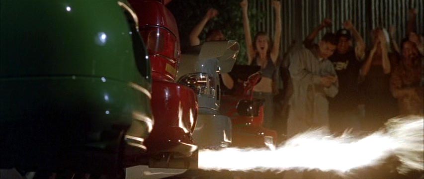 Back bumpers of cars with flames coming out of the tailpipe