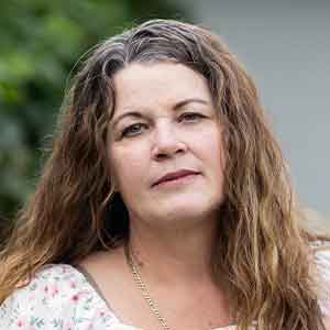 A small headshot of Christy Palmer, a former Cognizant employee.