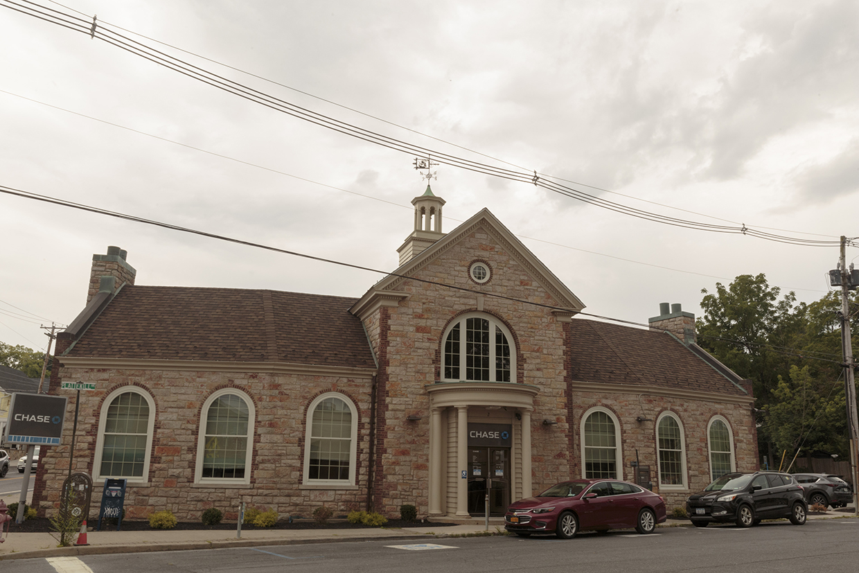 A photo of a brick building with a Chase sign on it.
