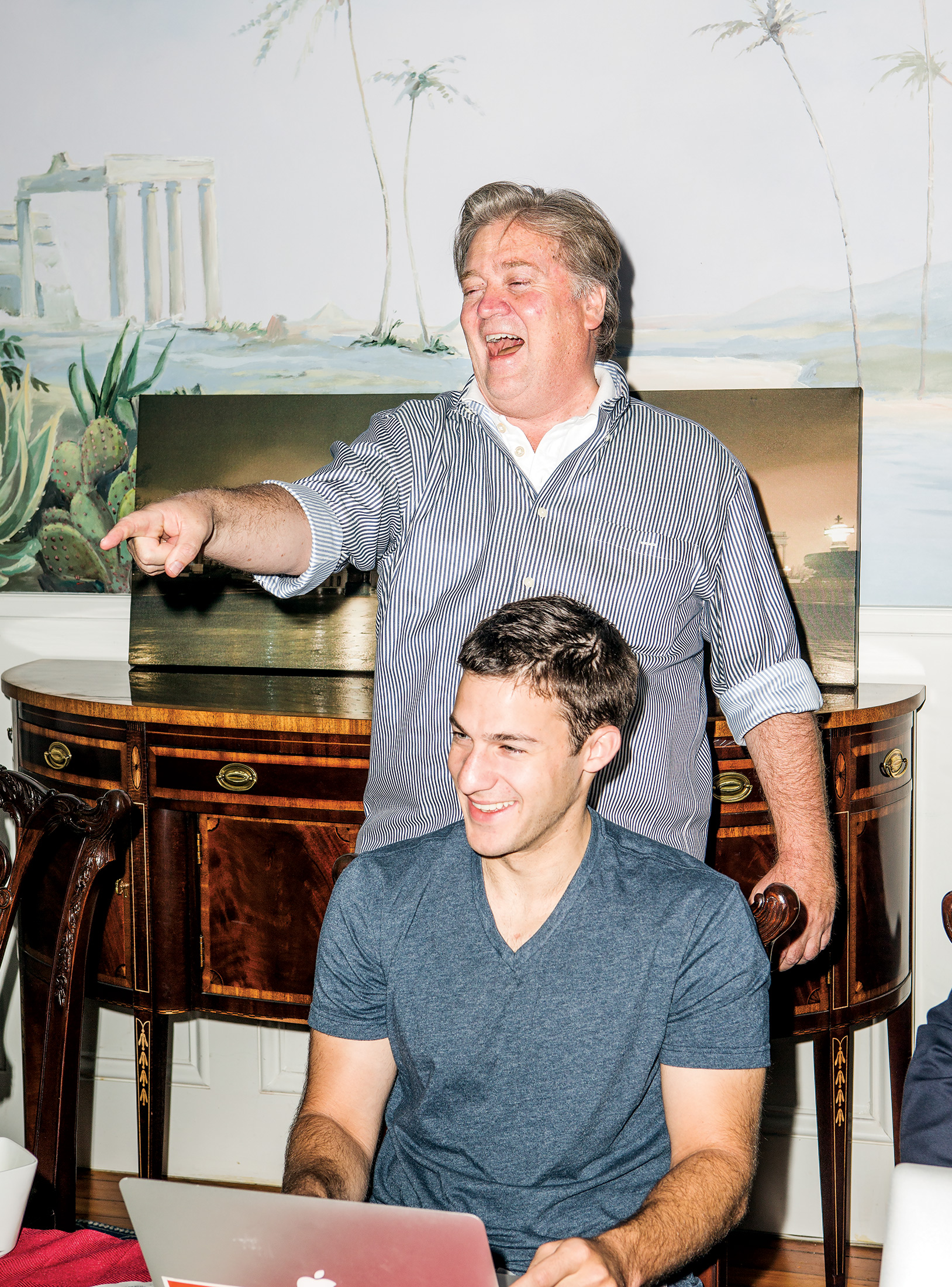 Bannon laughing and pointing with coworker